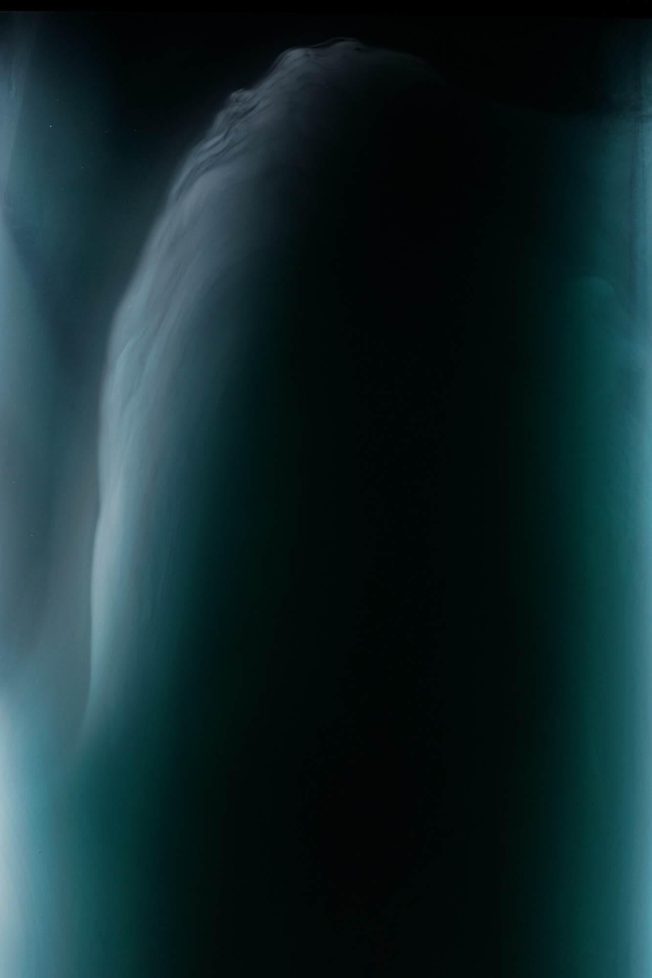 cloud chamber — illuminated fog inside a glass volume